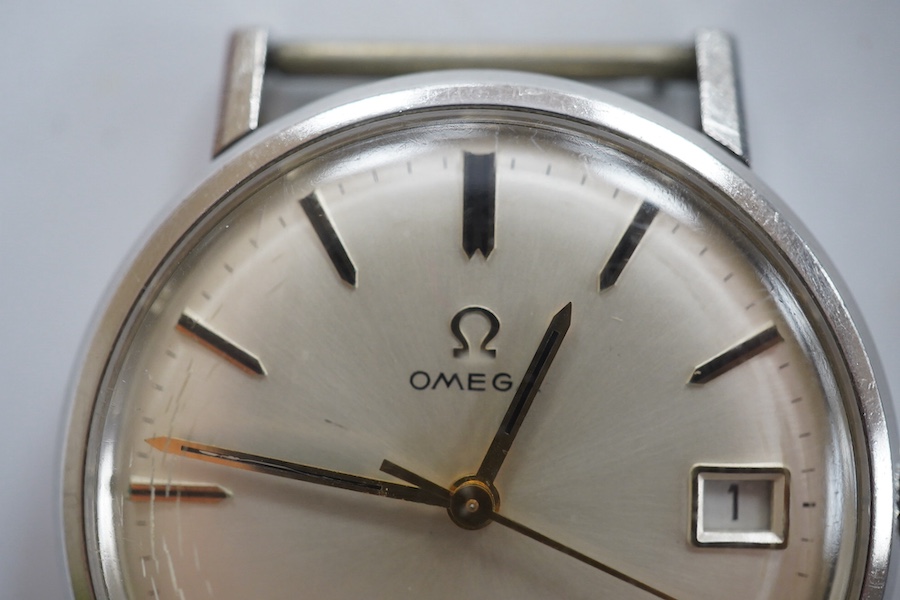 A gentleman's stainless steel Omega manual wind wrist watch, with baton numerals and date aperture, case diameter 34mm, no strap, with a 1970's service receipt. Condition - fair